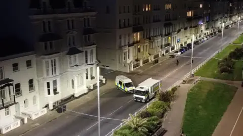 Dan Jessup An aerial image of the police cordon put in place on the A259, with police tape and vehicles blocking the road