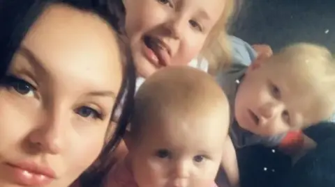 UGC Bryonie Gawith, 29, pictured with her three children Denisty, nine, Oscar, eight, and Aubree, 22 months