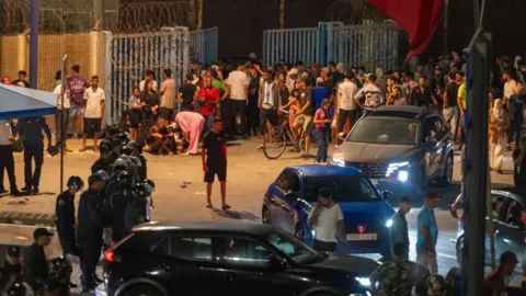 EPA People gather at the Bab Sebta border crossing between Morocco and the Spanish enclave of Ceuta, near Fnideq, Morocc