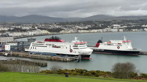 Two Steam Packet ferries docked in Douglas Harbour with Douglas seafront in the background on an overcast day.