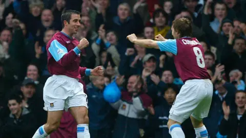 Getty Images Kevin Horlock celebrates a West Ham goal with a team-mate. They are wearing the claret and blue strip in front of a cheering crowd.