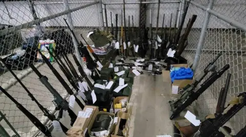 Royal Canadian Mounted Police The image shows rifles and ammunition in a cage