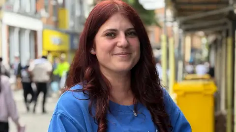 Chloe Hunter wearing a blue top and smiling