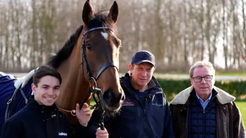 PA Jockey Ben Jones, trainer Ben Pauling and owner Harry Redknapp alongside The Jukebox Man during a media morning at the Naunton Downs Estate