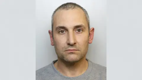 Avon and Somerset Police Mug shot of Antony Snook. He is wearing a grey t-shirt.