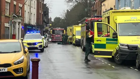 General view of ambulances, fire crews and police cars on the High Street in Cheadle