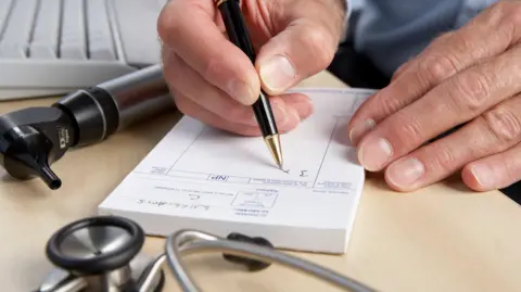 Getty Images Doctor writing prescription