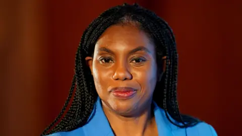 PA Media Conservative Party leader Kemi Badenoch wearing a blue suit looks into the crowd as she speaks at the Centre for Policy Studies conference at Guildhall in London