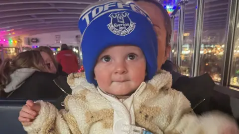 Ronnie in fawn fleecy jacket and Everton bobble hat