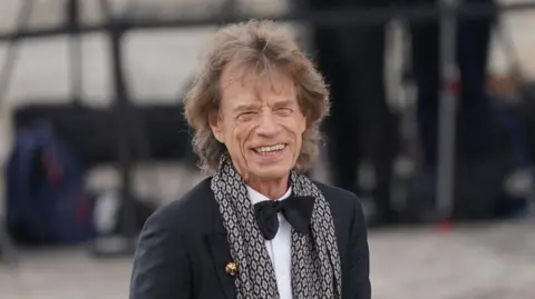 Mick Jagger wearing black tie for a formal event. 