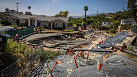 Getty Images A destroyed street and neighbourhood
