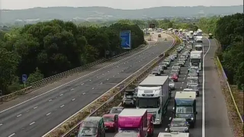 A huge traffic jam on the M5 in Somerset. One side of the motorway is clear, while the other is congested.