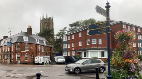 BBC Image with a signpost, with a view of Castle Hotel and the cathedral in the background