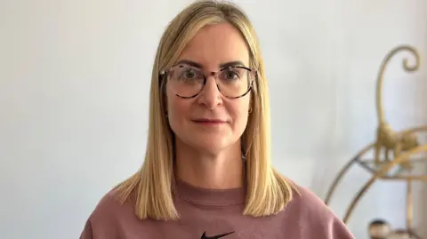 Sarah Fletcher in a pink top