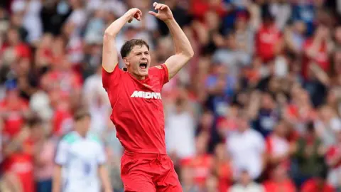 Will Lankshear raises both arms in celebration at scoring Middlesbrough's equaliser in their 2-1 win over Lincoln City on Saturday.