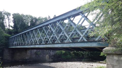 A blue steel bridge across a river.