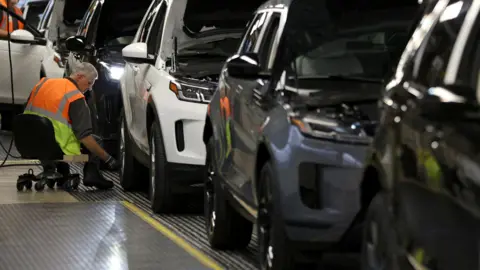 Reuters Worker on production line at Jaguar Range Rover's site in Halewood