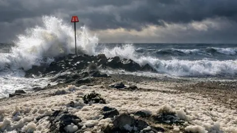 Highcliffe, Christchurch Dorset - beach with large waves crashing in