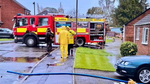 A fire engine pumps water from houses in Shirland