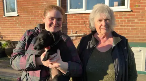 Luna being held by Lola Glide next to Rose Milne