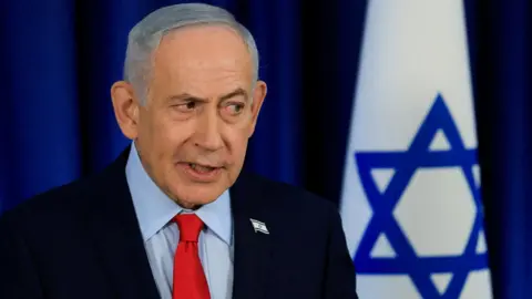 Reuters FILE PHOTO: Israeli Prime Minister Benjamin Netanyahu, wearing a dark suit, red tie and light blue shirt, speaks during a news conference