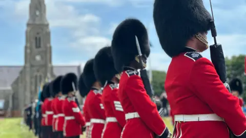 The guard of honour lining the ceremonial walkway with the chapel in the distance.