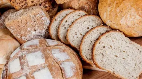 Getty Images A variety of different breads, arranged on a table