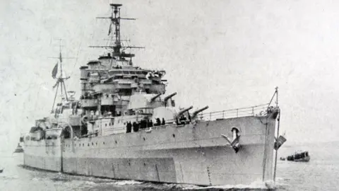Universal History Archive/UIG via Getty images Old Black and while image of large metal navy ship in the sea, with large guns and masts.
