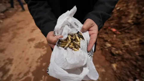 Reuters Bullet casings being held in a white plastic bag. 