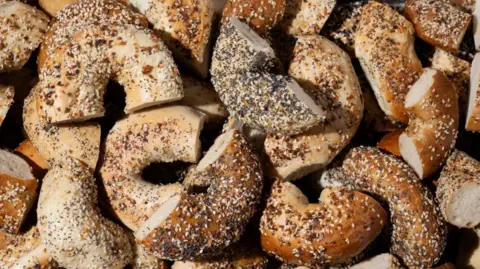 Everything bagels baked with a mix of toppings including garlic flakes, onion flakes, poppy seeds, sesame seeds and salt