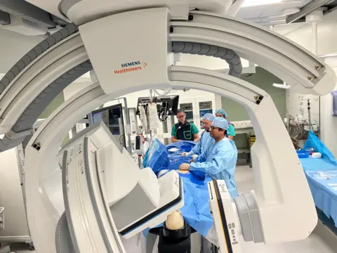 Staff at the QMC work on a mock procedure, using a dummy to show how they would usually carry out IR procedures