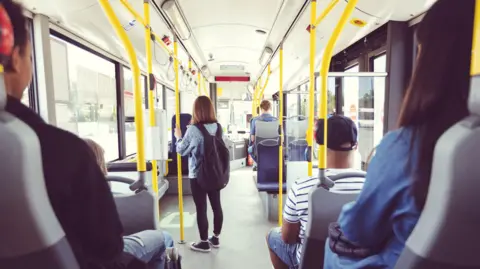 
Males and females commuting by public transport - stock photo
Men and women traveling in public transport. Teenage girl is standing at aisle while commuting by bus. They are in vehicle.