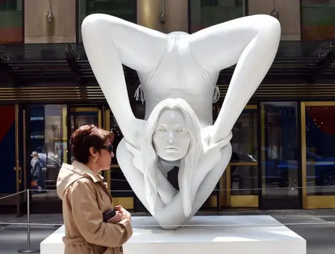AFP via Getty Images A woman passes by a sculpture by Marc Quinn titled "Myth Venus" before the start of the afternoon session auction May 14, 2014 at Christie's Morning & Afternoon Session of Post-War and Contemporary Art in New York.