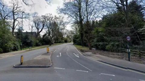 Google A road lines with trees and a 40mph sign
