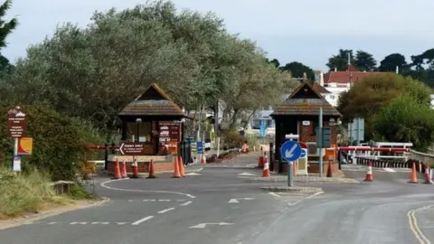 Oast House Archive Two toll collection booths next to road barriers on Ferry Road.
