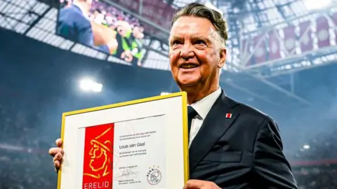 Louis van Gaal with a memento to commemorate being named an honorary member of Ajax in November 2024
