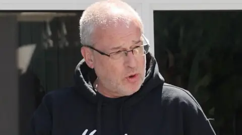 man in glasses and black hoody