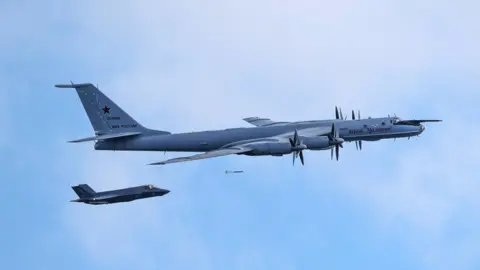 Handout photo issued by Ministry of Defence of a F-35B fighter launched from HMS Prince of Wales intercepting a Russian Tupolev Tu-142 maritime reconnaissance and anti-submarine warfare (ASW) aircraft.