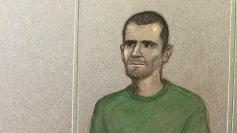 Court artist drawing of Marcus Monzo in the dock at the Old Bailey. He is sketched wearing a green jumper and has short dark hair and stubble.