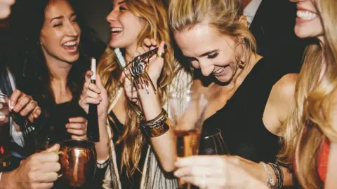 Stock image of women dancing and drinking at a party