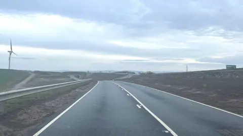 The single carriageway old A30 with no traffic, and part of the new A30 upgrade visible in the distance.