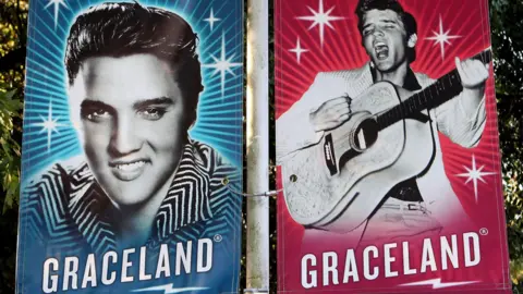 Banners showing Elvis Presley's face outside Graceland