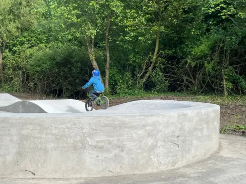 Now Child biking on skatepark