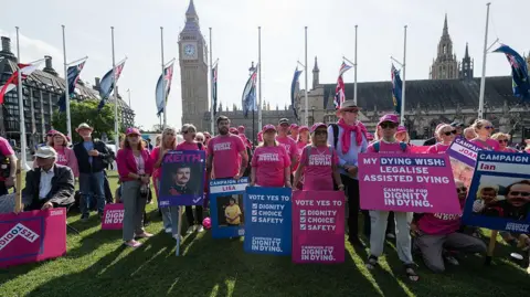 Protesters for and against assisted dying hold colourful placards in Parliament Square