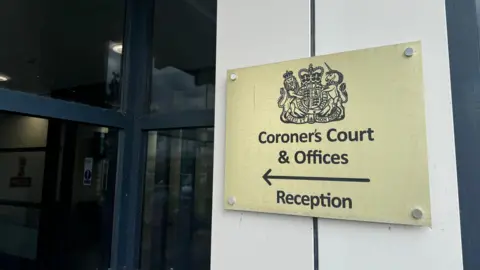 George King/BBC A sign for Suffolk Coroner's Court