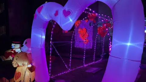 Sandra Lee Myles Valentine's Day decorations. An inflatable heart decoration, pink lights and inflatable teddy bears.