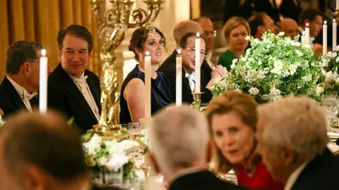 AFP via Getty Images US Supreme Court Associate Justice Brett Kavanaugh (2nd-L) attends a State Dinner with US President Donald Trump, First Lady Melania Trump, Britain's King Charles III and Queen Camilla in the East Room of the White House in Washington, DC, on April 28, 2026. (Photo by Brendan SMIALOWSKI / AFP via Getty Images)
