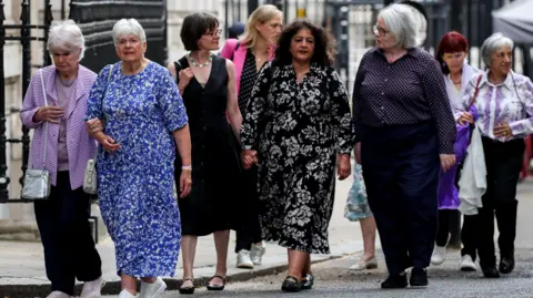 Campaigners arrive for a meeting with Britain's Prime Minister Keir Starmer at Downing Street, to discuss historical forced adoption, 