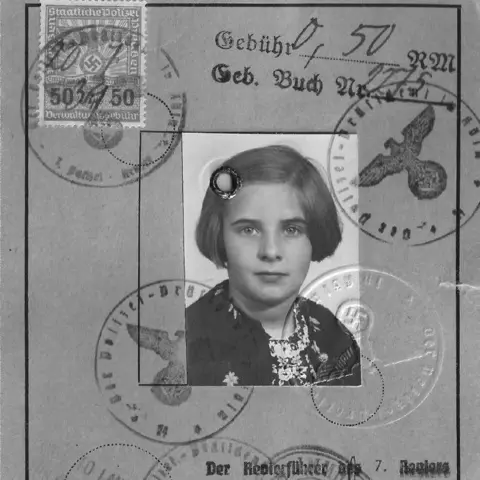 Nottingham Trent University Hanna Zack's identity card, bearing a black and white photograph of a girl with bobbed hair. The card has several Nazi official stamps