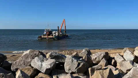 Rocks being delivered off the coast of Cromer